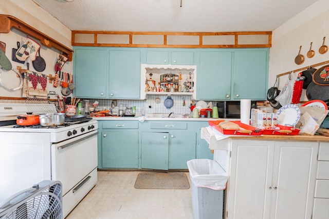 kitchen with white gas range oven, blue cabinets, light countertops, light floors, and open shelves