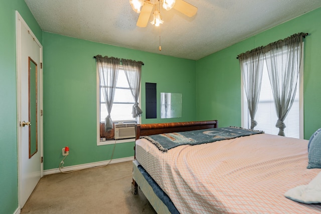 carpeted bedroom with a ceiling fan, cooling unit, a textured ceiling, and baseboards