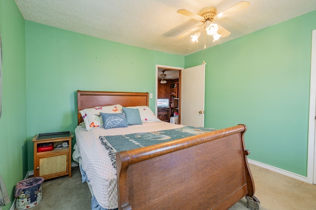 bedroom with ceiling fan, a textured ceiling, baseboards, and carpet flooring