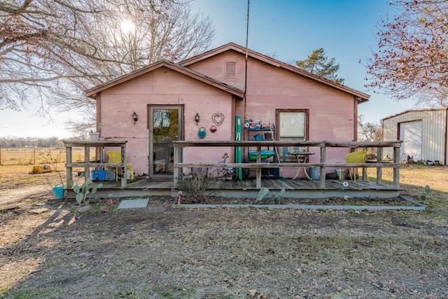 view of front of home featuring an outdoor structure and a wooden deck