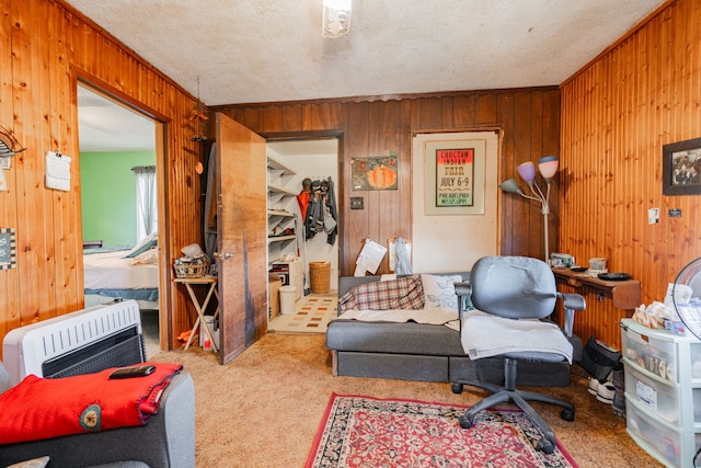 interior space featuring carpet floors, wooden walls, a textured ceiling, and heating unit