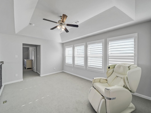 sitting room featuring baseboards, a raised ceiling, visible vents, and light colored carpet