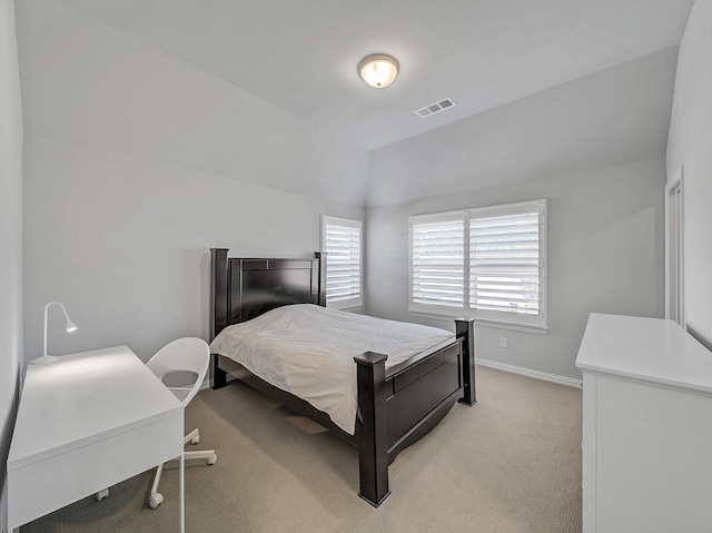 bedroom featuring light colored carpet, visible vents, vaulted ceiling, and baseboards