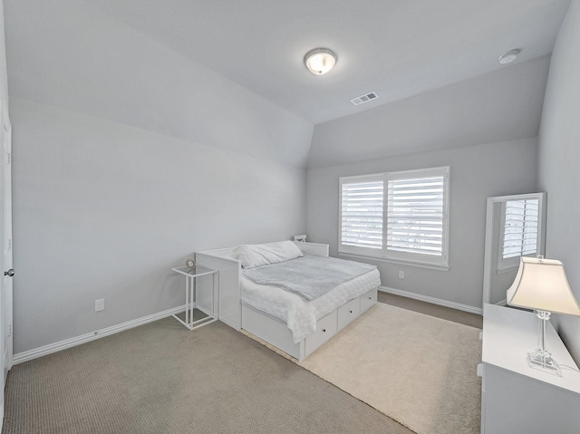 bedroom with lofted ceiling, carpet, visible vents, and baseboards