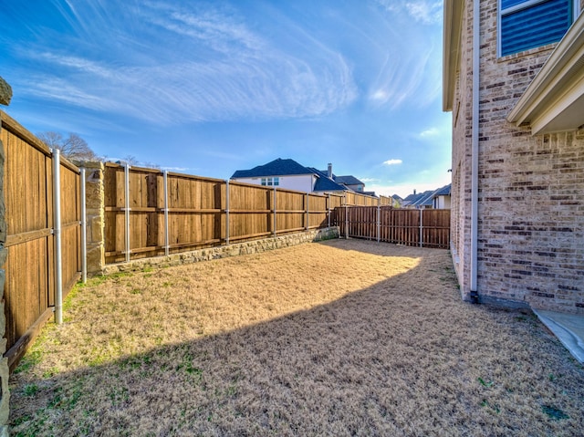 view of yard with a fenced backyard