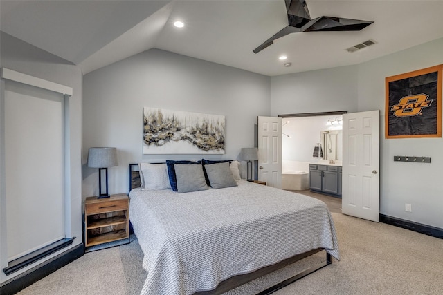 bedroom with lofted ceiling, visible vents, ensuite bathroom, light carpet, and baseboards