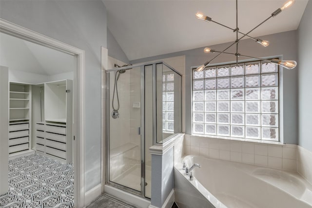 bathroom featuring a shower stall, a spacious closet, vaulted ceiling, and a bath