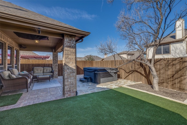 view of yard featuring a hot tub, a patio area, a fenced backyard, and an outdoor living space