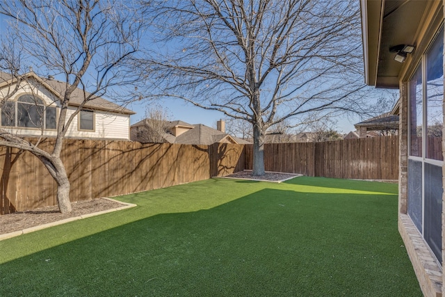 view of yard featuring a fenced backyard