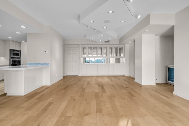 unfurnished living room featuring light wood-style floors, visible vents, baseboards, and recessed lighting