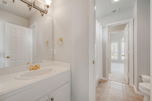 3409 Windridge Dr, Garland, TX 75043 - bathroom with toilet, vanity, tile patterned floors, and baseboards