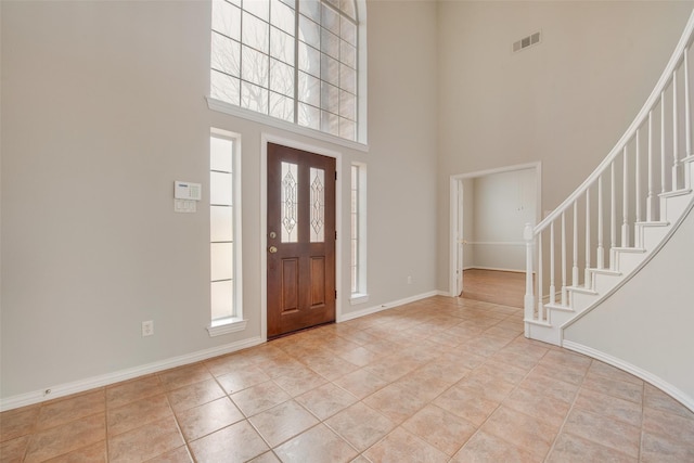 3409 Windridge Dr, Garland, TX 75043 - entrance foyer with a towering ceiling, stairs, plenty of natural light, and baseboards