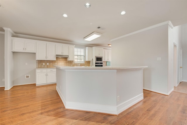 kitchen featuring visible vents, white cabinets, light wood-style flooring, appliances with stainless steel finishes, and crown molding