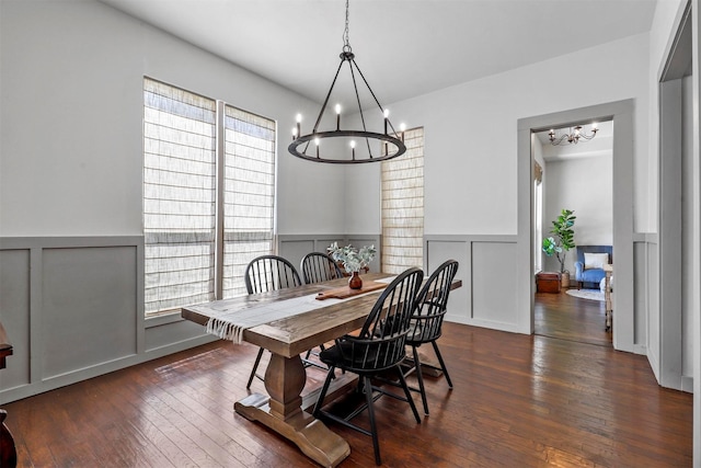 115 N 1st St, Midlothian, TX 76065 - dining room with a chandelier, a decorative wall, dark wood-type flooring, and wainscoting