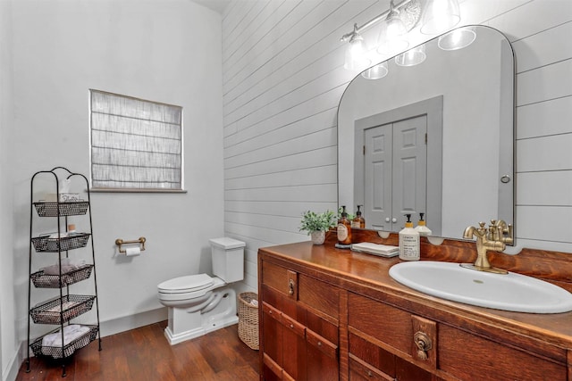 115 N 1st St, Midlothian, TX 76065 - bathroom featuring toilet, vanity, wood finished floors, and wood walls