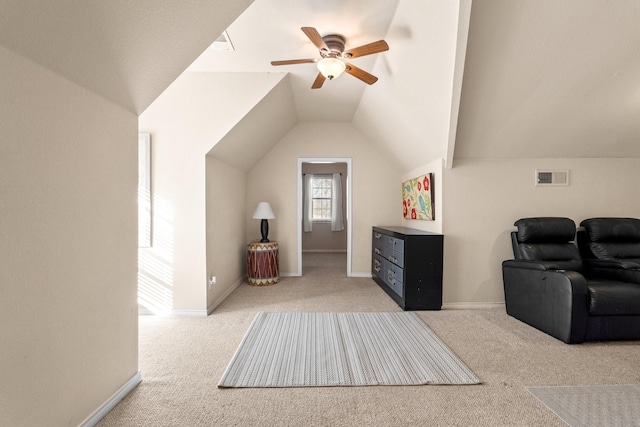 interior space featuring carpet flooring, a ceiling fan, vaulted ceiling, and visible vents