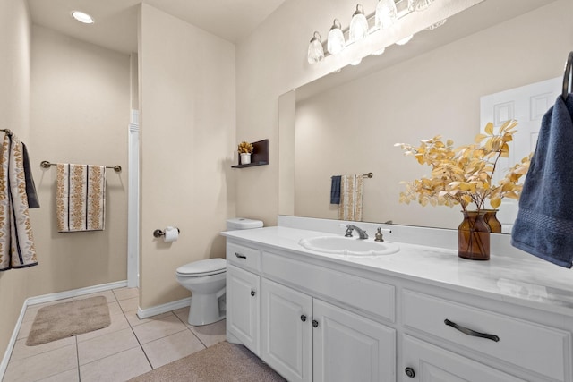 bathroom with baseboards, toilet, tile patterned floors, and vanity