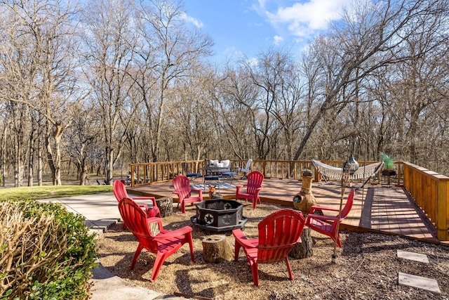 view of patio / terrace with a fire pit and a wooden deck