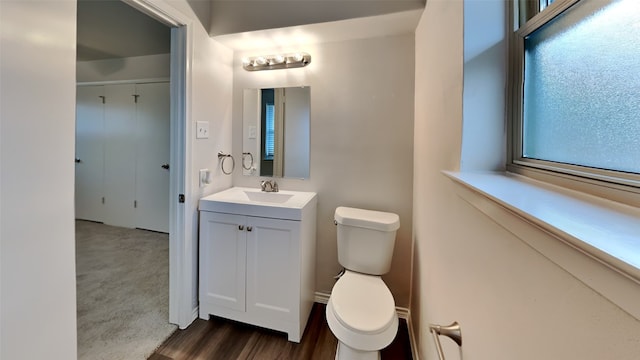 bathroom featuring vanity, toilet, and wood finished floors