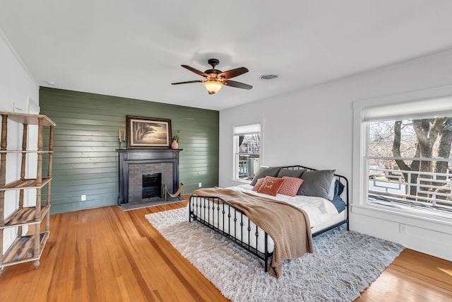 bedroom featuring multiple windows, light wood-type flooring, and visible vents