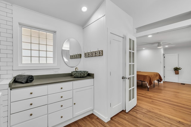 bathroom featuring ceiling fan, wood finished floors, vanity, and recessed lighting