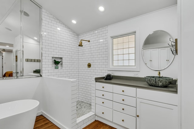 bathroom with a walk in shower, wood finished floors, lofted ceiling, and vanity