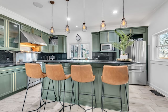 kitchen with green cabinets, dark countertops, visible vents, and under cabinet range hood