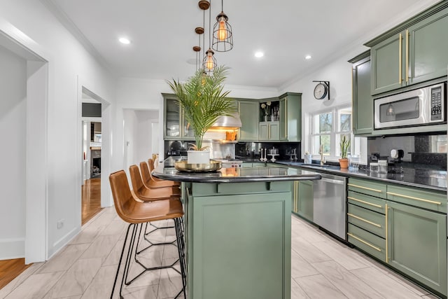 kitchen featuring stainless steel appliances, dark countertops, and green cabinetry