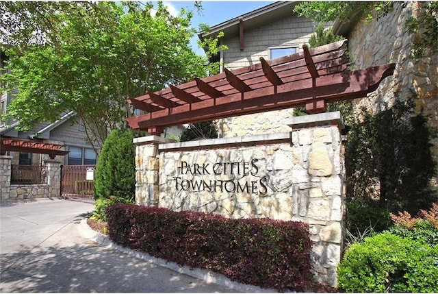 community / neighborhood sign with fence