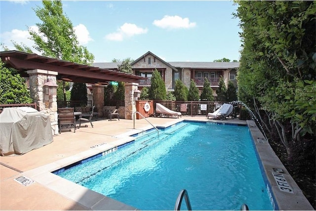 pool featuring a patio area, fence, grilling area, and a pergola