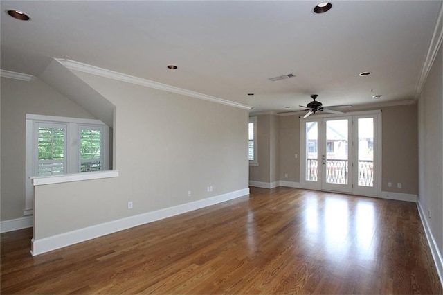 spare room featuring a healthy amount of sunlight, ornamental molding, and wood finished floors