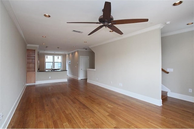 unfurnished living room with visible vents, stairway, baseboards, and wood finished floors