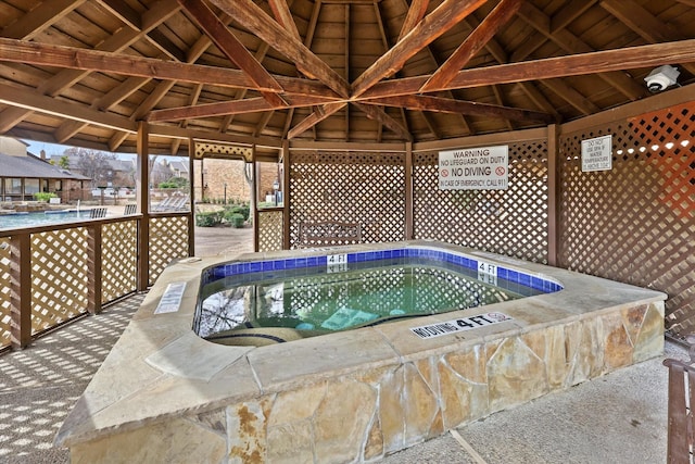 view of pool with a hot tub and a gazebo