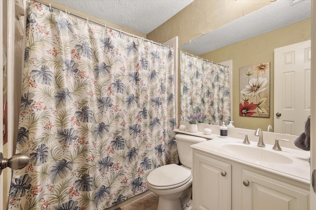 bathroom with a textured ceiling, tile patterned flooring, toilet, a shower with shower curtain, and vanity