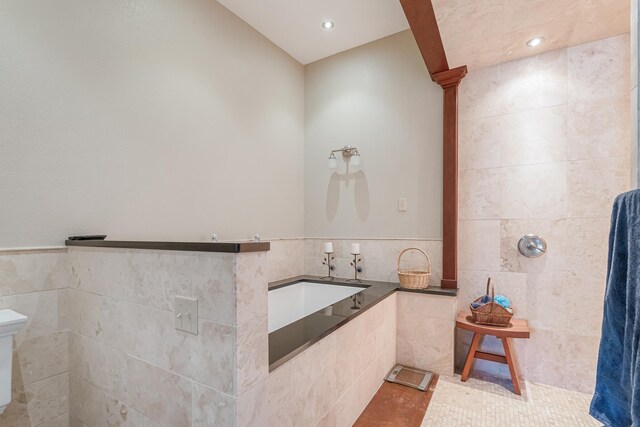 310 County Road 336 Unit B, Tuscola, TX 79562 - full bathroom featuring tile patterned floors, a wainscoted wall, toilet, tile walls, and ornate columns