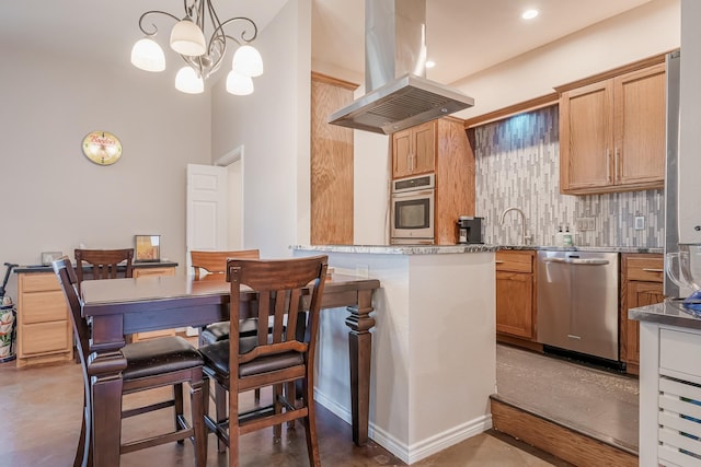 310 County Road 336 Unit B, Tuscola, TX 79562 - kitchen with tasteful backsplash, hanging light fixtures, island range hood, a chandelier, and stainless steel appliances