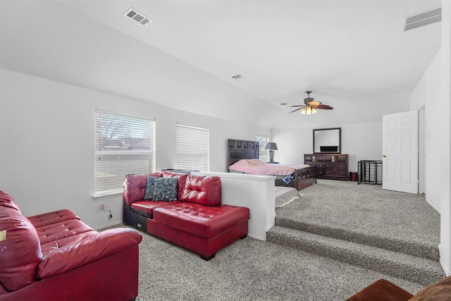 living room with a ceiling fan, visible vents, vaulted ceiling, and carpet flooring