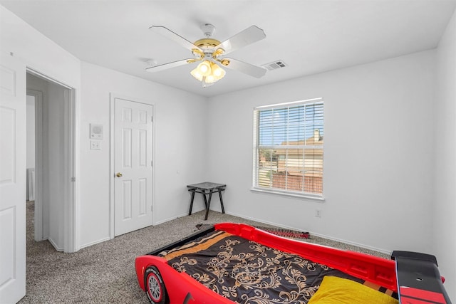 carpeted bedroom with visible vents and a ceiling fan