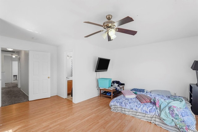 bedroom featuring a ceiling fan, baseboards, and light wood finished floors