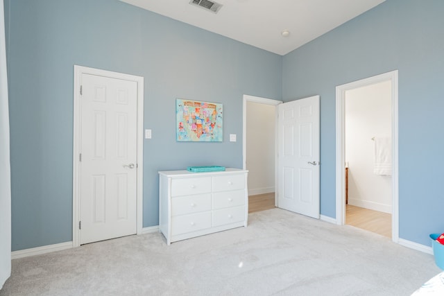 unfurnished bedroom featuring carpet flooring, visible vents, and baseboards