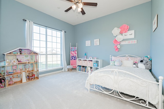 carpeted bedroom with a ceiling fan and baseboards