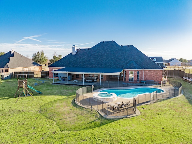 view of swimming pool featuring a playground, a fenced backyard, a pool with connected hot tub, a yard, and a patio area