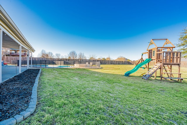 view of yard featuring a playground, a fenced backyard, and a fenced in pool