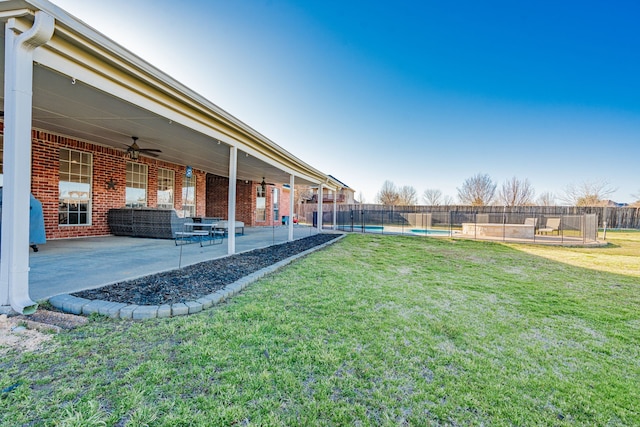 view of yard featuring a fenced in pool, fence, a ceiling fan, and a patio