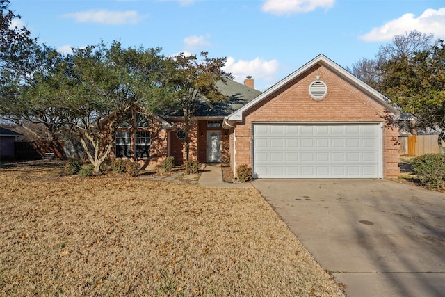 view of front facade with a garage, a chimney, and concrete driveway