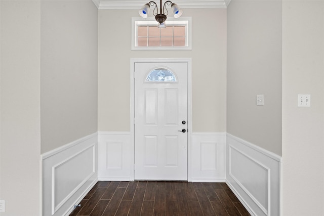 entryway featuring ornamental molding, wainscoting, and dark wood finished floors