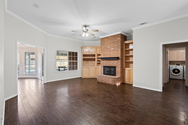 unfurnished living room with a fireplace, visible vents, a ceiling fan, dark wood finished floors, and washer / dryer