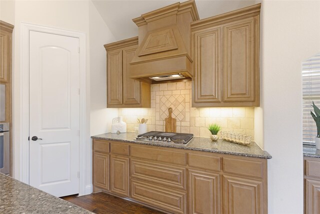 kitchen featuring backsplash, wall oven, custom range hood, and stainless steel gas stovetop