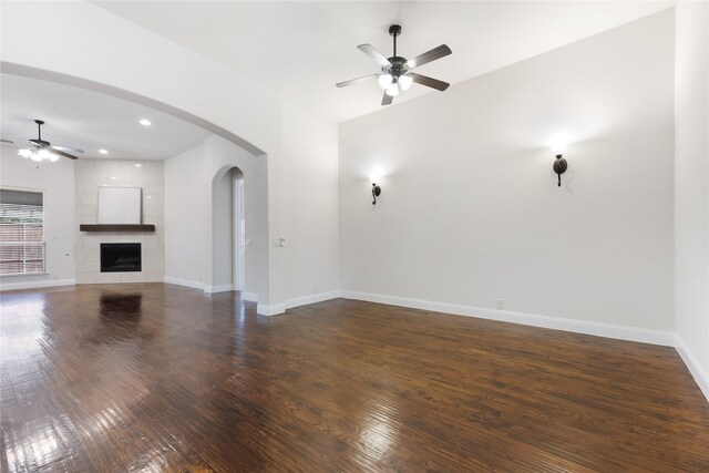 unfurnished living room featuring baseboards, ceiling fan, and hardwood / wood-style flooring