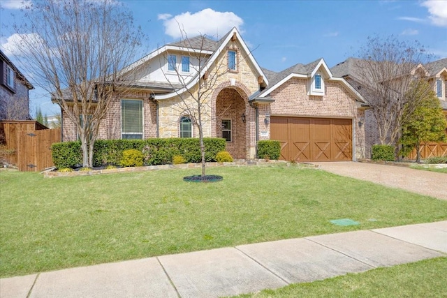 view of front of house featuring brick siding, a front lawn, fence, a garage, and stone siding